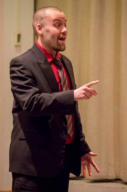 Close-up of Connor Gibbs singing with a shocked expression.