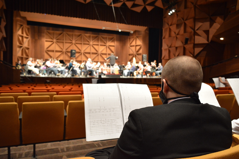 Connor looking at the Toledo Symphony rehearse his orchestral work.