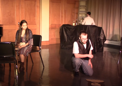 Connor Gibbs admires a painting during an opera scene.