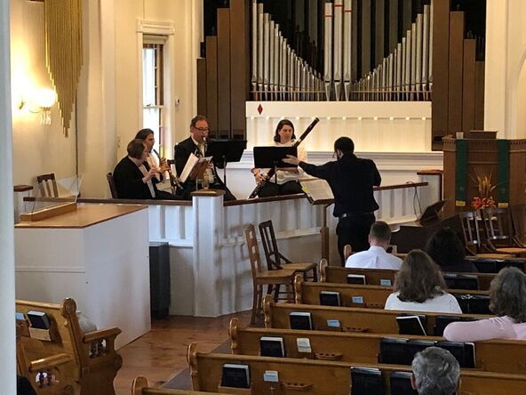 Connor conducts the premiere of his woodwind quartet.