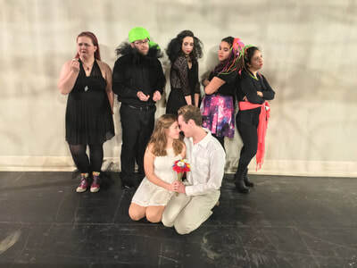 Cast of opera production dressed up as jesters.