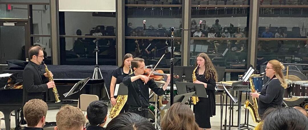 Cole Habekost plays violin, accompanied by saxophone quartet.