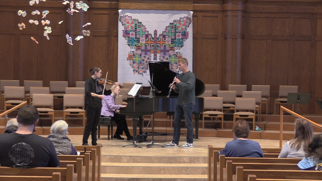 A performance of Connor's trio composition Unity in a church sanctuary.