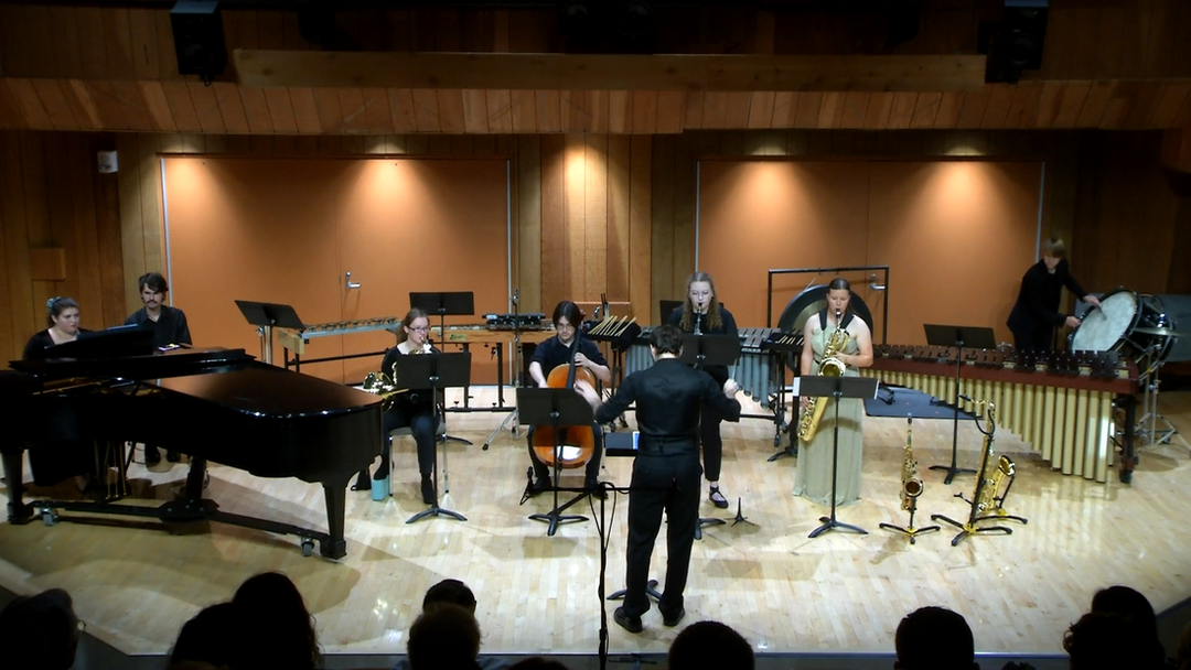 Thomas Fortner performs Connor's solo work for cello. (Thomas drags his bow with both hands across the Low C string.)