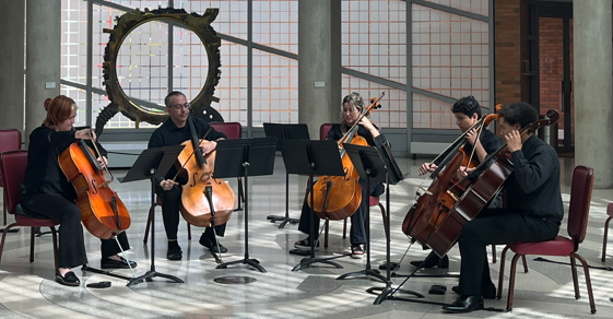 Five cellists performing the first movement of Connor's 45/32 named 