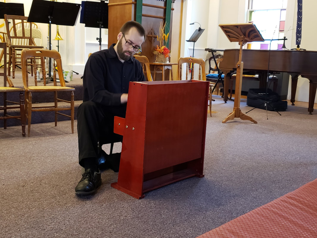 Connor plays a red, 3-octave toy piano.